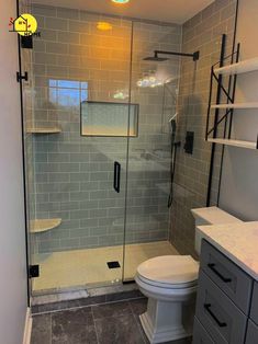 a bathroom with a walk in shower next to a toilet