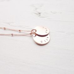 "I am in love with the color of rose gold! I'm excited to offer my best selling necklace in this warm, luxurious metal! The names of your choosing are hand stamped on rose gold filled medallions and lay on a delicate beaded rose gold filled chain. . { d e t a i l s } . Made to order. rose gold filled. . { m e a s u r e m e n t s } . 1/2\" disc 16 or 18\" in length . { o p t i o n s } . Please leave personalization preference in the notes to camileedesigns field at checkout This design in traditi Rose Gold Sterling Silver Tarnish Resistant Charm Necklaces, Mother's Day Rose Gold Charm Necklace Tarnish Resistant, Rose Gold Charm Necklaces For Mother's Day, Dainty Adjustable Rose Gold Charm Necklace, Adjustable Engraved Rose Gold Necklace, Rose Gold Sterling Silver Charm Necklace For Mom, Minimalist Rose Gold Hand Stamped Charm Necklaces, Mother's Day Rose Gold Tarnish-resistant Charm Necklace, Minimalist Rose Gold Hand Stamped Charm Necklace