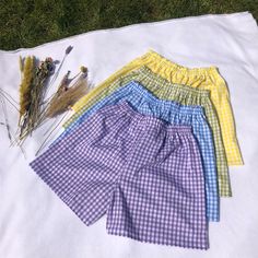 "These high waisted Gingham shorts are perfect for the spring! They have an elastic waistband with two lines of top stitch for a sporty yet elegant look. (1/4\" Gingham) Gingham shorts are approx 43cm long (can be made longer/shorter) - polycotton -Machine Washable Check out our website for more! https://eccentriclothing.bigcartel.com/products Instagram @eccentricclothing" Summer Plaid Shorts With Built-in Shorts, Trendy Gingham Shorts, Spring High-waisted Pajama Shorts, Summer Gingham Bottoms With Elastic Waistband, Trendy Gingham Bottoms Short Length, Trendy Gingham Summer Shorts, Trendy Gingham Short Length Bottoms, Trendy Gingham Bottoms In Short Length, Summer Plaid Bottoms With Built-in Shorts