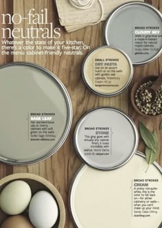 some eggs are sitting in tins on a table with other paint colors and ingredients