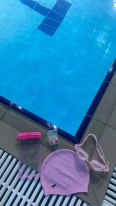 an empty swimming pool with some items on the floor next to it and a water bottle