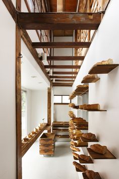 a long hallway with wooden shelves filled with bread