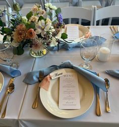 the table is set with silverware, plates and napkins for an elegant dinner