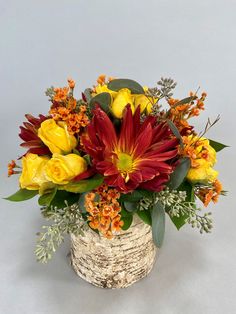 a basket filled with lots of flowers on top of a table