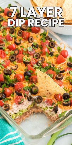 a casserole dish with tortilla chips and black olives