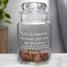 a glass jar with some chocolates in it