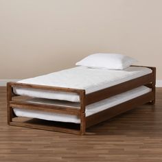 a wooden bed frame with two white pillows