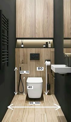 a bathroom with wood paneling and white fixtures, including the measurements for the toilet