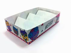 an open box with cartoon characters on the lid and bottom, sitting on a white surface