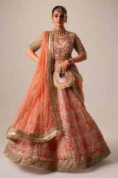 Premium Pakistani Bridal Dress in Organza Choli Lehenga Style is adorned with hand-crafted details of dabka, gota, kora, naqshi, and threads. The choli has an alluring pink shade and the Bridal Lehenga is multi-colored, creating a lavish Lehenga Dress for the bride to wear on the big day. Semi-stitched Embroidered Gown For Navratri, Dabka Work Dress For Reception, Transitional Reception Dress With Resham Embroidery, Transitional Reception Dresses With Dupatta, Traditional Raw Silk Dress For Reception, Designer Gown With Intricate Embroidery For Navratri, Embroidered Kundan Floor-length Gown, Traditional Dresses With Zari Work For Reception, Traditional Zari Work Dresses For Reception