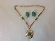 "1928 faux pearl, faux green stone locket pendant necklace, clip-on earrings set All sizes approximately- Earrings, clip-on: 1.25\" x 1\" Necklace: drop 2.25\", locket diameter - 1.5\" and chain - 19\" with barrel clasp. necklace marked: 1928 clip-on earrings unmarked. Heavy and good quality. Excellent vintage condition." Green Hand-set Gold-plated Necklace, Antique Green Locket Jewelry, Vintage Green Cabochon Earrings, Antique Green Clip-on Jewelry, Elegant Green Gemstone Clip-on Earrings, Locket Pendant Necklace, Plastic Jewelry, Rhinestone Necklace, Green Stone