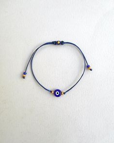 "Evil Eye Bracelet Gold beads Blue Evil Eye String Bracelet, Minimalist Lucky Bracelet Protection Greek jewelry Good luck gift Wish bracelet Lucky Rat Jewellery best selling Red string evil eye bracelet! -CHOOSING THE CORRECT SIZE- The bracelet in general is adjustable so it needs to be long enough to pass over someone's wrist. So approximately the wrist sizes are(excluding the cords hanging): Kids : 5 to 5.5\" teens: 5.5 to 6\" Women: 6 to 7\" Men: 7 to 8\" This simple yet beautifull bracelet i Blue Spiritual Braided Bracelets Hand-strung, Blue Beaded Spiritual Bracelets With Sliding Knot, Blue Spiritual Beaded Bracelets With Sliding Knot, Gold Braided Evil Eye Bracelet As A Gift, Spiritual Blue Beaded Bracelets With Sliding Knot, Blue Spiritual Bracelets With Sliding Knot, Gold Braided Bracelet With Evil Eye For Gift, Gold Braided Bracelet With Evil Eye As Gift, Blue Spiritual Bracelet With Sliding Knot