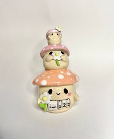 three ceramic figurines stacked on top of each other with flowers in the middle