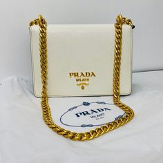 Free Authentification! New Prada - Chain Flap Bag Saffiano Leather * White And Black Leather * Gold Hardware * Crossbody * 8"W X 6"H X 2"D12" Handle Drop21" Strap Drop Classic White Bags With Logo Plaque, White Shoulder Bag For Evening With Original Box, Elegant White Shoulder Bag With Logo Plaque, White Rectangular Bag With Logo Plaque, Formal Saffiano Leather Bag With Chain Strap, Elegant Gold Saffiano Leather Shoulder Bag, White Leather Bags With Logo Plaque, Designer Gold Saffiano Leather Shoulder Bag, Classic White Bags With Gold-tone Logo Plaque