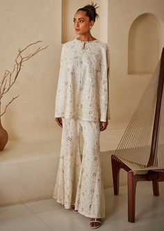 The garment is made in georgette, with chikankari embroidery embellished with sequins and styled by the designers at our studio with the finest details. Cape For Women, Chikankari Embroidery, White Cape, Nyc Studio, White Flares, Capes For Women, Cape Sleeves, Bootcut Pants, Pattern Embroidery