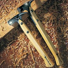 two woodworking tools sitting on top of a wooden table