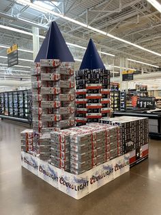 two stacks of cans stacked on top of each other in a building with metal ceilinging