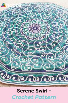 the crochet pattern is shown in blue and white, with an intricate design on it