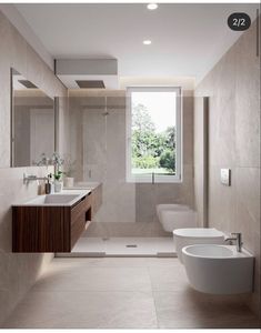 a modern bathroom with two sinks, toilet and bathtub in the middle of it