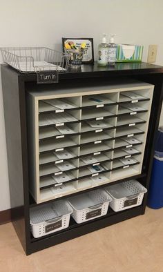 a shelf with several bins and baskets on it