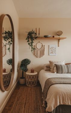 a bed room with a neatly made bed and a mirror