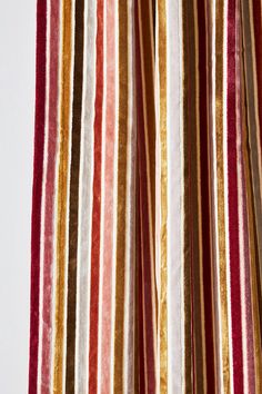 the curtain is striped with red, yellow and brown stripes