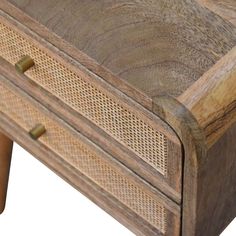 a close up of a wooden drawer with wicker on the top and bottom drawers