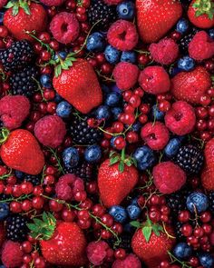 berries, raspberries and blueberries are arranged together