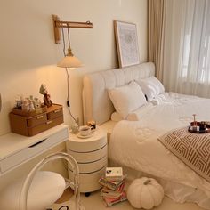 a bedroom with a white bed and lots of pillows