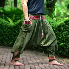 "Green Tribal pants, Hmong pants, Traditional Thai pants, Harem pants, Unisex pants Tribal pants is very comfortable and easy to wear, Unisex for Men and Women Every Detail of Tribal pants is made by Thai Craftsmanship. Tribal pants is inspired by Tribal in the North of Thailand or Hmong. Redesign for easy to wear and comfy. Great for many occasion activities like Chilling time, Casual wear, Relax time. This item is made of high-quality cotton in the north of Thailand. Printed with Special techn Traditional Baggy Bottoms For Spring, Traditional Style Baggy Pants For Spring, Traditional Baggy Pants For Spring, Baggy Green Pants For Festival, Green Baggy Pants For Festival, Harem Pants With Pockets For Festivals, Traditional Spring Pants With Pockets, Casual Pants With Pockets For Festivals, Casual Festival Pants With Pockets