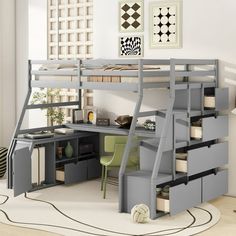 a loft bed with desk underneath it and storage drawers under the bottom bunk, in a white room