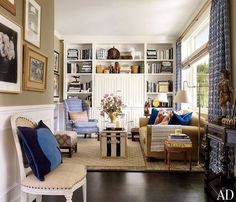 a living room filled with furniture and bookshelves