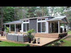 a small house sitting on top of a wooden deck