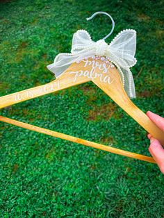 a person holding two wooden clothes hangers with the words mr and mrs written on them