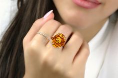 An adorable piece from Anemone's collection of birthstone rings for women. It features a stunning November birthstone, an oval-shaped Citrine set in 925 Sterling silver. With its magnificent color, this Citrine ring is sure to steal the show. Custom-made for you or your loved one's ring size. ☛ 𝒜𝐵𝒞 - Add Engraving - https://etsy.me/2ZSRjhu ☛ Ring size - Select the size you would like from the drop down menu ♥ Gemstone Type - Citrine (Heated) ♥ Gemstone Size - 16x20mm ♥ Gemstone Cut - Faceted Oval Citrine Solitaire Jewelry, Oval Solitaire Citrine Jewelry, Oval Citrine Birthstone Crystal Ring, Oval Citrine Crystal Ring With Birthstone, Oval Citrine Crystal Promise Ring, Oval Citrine Birthstone Ring With Accent Stones, Oval Topaz Ring With Accent Stones As Gift, Oval Crystal Ring With Accent Stones For Gift, Oval Citrine Diamond Promise Ring