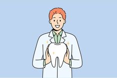 a man in a lab coat holding a tooth