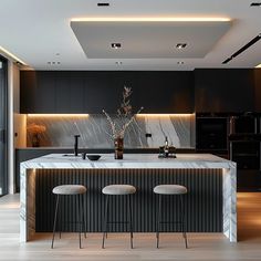 a modern kitchen with marble counter tops and stools