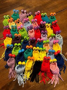 there are many crocheted owls sitting on the floor with one eye open and two eyes closed