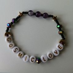 a bracelet that says cosmic love on it