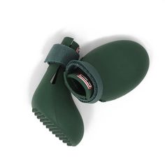 a pair of green rain boots on top of a white surface with the soles open