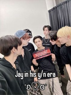 a group of young men standing next to each other in front of a sign that says jay in his y'n era