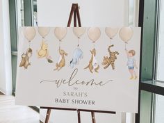 a baby shower sign with winnie the pooh and friends holding balloons in front of it