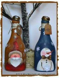 two wine bottles decorated with santa and snowmen