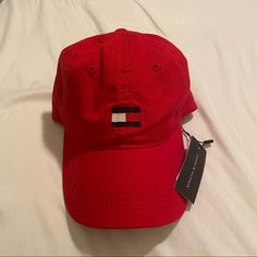 Red Cap Tommy Unisex Never Worn University Red Casual Snapback Hat, Casual University Red Snapback Hat, Classic Red Baseball Cap With Curved Bill, Classic Red Baseball Cap With Visor, Classic Red Visor Baseball Cap, Classic Red Dad Hat With Curved Brim, University Red Snapback Baseball Cap, Casual University Red Snapback Baseball Cap, Classic Red Cotton Hat