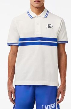 Sporty and French-inspired, this classic-fit polo features placed stripes, tipped edges and a silicone logo at the chest for iconic Lacoste style. 28" length Button half placket Spread collar Short sleeves 100% cotton Hand wash, line dry Imported White Collared Polo Shirt With Signature Stripes, Classic Three Stripes Polo Shirt, Classic Three-stripes Polo Shirt, Sporty Blue Polo Shirt With Contrast Stripes, Casual Golf Polo Shirt With Contrast Stripes, Casual Polo Shirt With Contrast Stripes For Golf, Sporty Collared Polo Shirt With Three Stripes, Casual Three Stripes Polo Shirt For Golf, Sporty Striped Polo Shirt With Signature Stripes