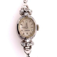 "Rare Ladies Collectable OMEGA 14k White Gold with approximately 1.25 carat of Natural Diamond Manual Wind Cocktail Watch.    It is set with 34 natural colorless diamonds weighing approximately 1.25 carats, the watch itself weighs 14.34 grams and is approximately 5.75\" inches in length.  Condition is Pre-owned. No original box, No original papers." Vintage Watch Claw, Classic Platinum Diamond Watch With Brilliant Cut, Classic Diamond White Watch With Brilliant Cut, Formal Diamond Jewelry With Vvs Clarity, Classic Diamond Jewelry With Brilliant Cut, Classic White Gold Jewelry With Brilliant Cut, Classic Diamond White Round Diamond Watch, White Diamond Round Watches, Classic Diamond Accented Watch For Anniversary