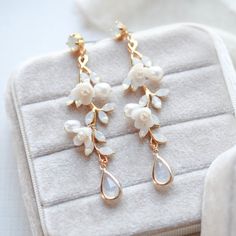 Our Lolita Gold Floral Freshwater Pearl Earrings will make your wedding day even more special. Carefully crafted with freshwater pearls and white opal Austrian crystals in an intricate floral design, these earrings will make you feel like an elegant and beautiful bride. Their timeless sophistication is the perfect finishing touch for your bridal look. - Handcrafted with genuine Austrian crystals - Created in my studio in PA- White opal crystals- Freshwater pearls- Polymer clay flowers- Yellow go Pearl Drop Flower-shaped Bridal Earrings, Rose Gold Pearl Drop Flower Earrings, Rose Gold Flower-shaped Earrings With Pearl Drop, Rose Gold Flower Earrings With Pearl Drop, Rose Gold Flower Drop Earrings With Pearl, Elegant Rose Gold Flower-shaped Pearl Earrings, Delicate Rose Gold Pearl Earrings For Wedding, Pearl Flower-shaped Wedding Jewelry, Rose Gold Pearl Bridal Earrings For Anniversary