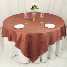 a round table with two wine glasses on it