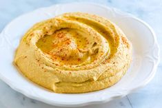 an image of hummus on a white plate