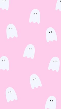 a pink background with white ghost faces on it